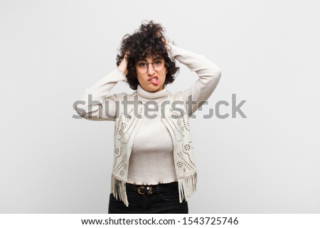 young pretty afro woman feeling frustrated and annoyed, sick and tired of failure, fed-up with dull, boring tasks