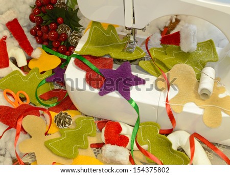 Christmas preparation background with sewing machine and funny textile figures