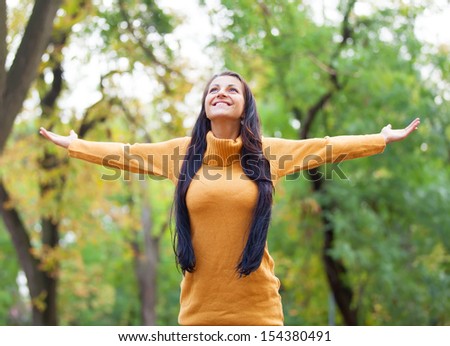 Brunette girl at autumn alley in the park