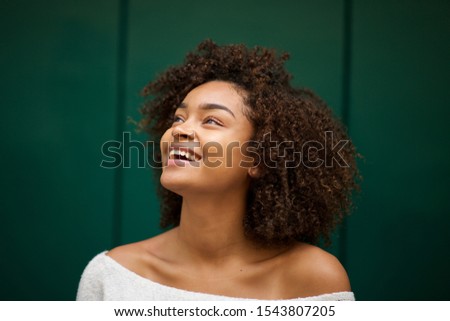 Close up portrait of young african american woman smiling and looking up