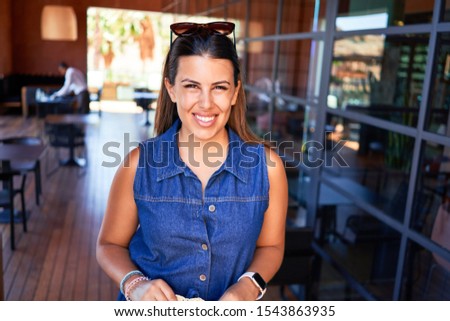 Young beautiful woman smiling happy and positive indoors of hotel resort on summer vacation