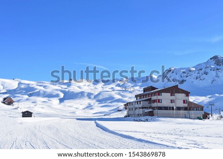 Beautiful walkway on the white snow in Melchsee Frutt in Swiss alps and blue sky background. 