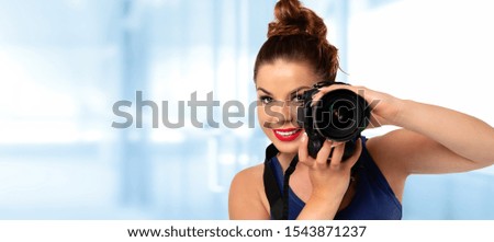 Photographer banner - beautiful and attractive woman holding a professional DSLR camera and smiling (copy space)