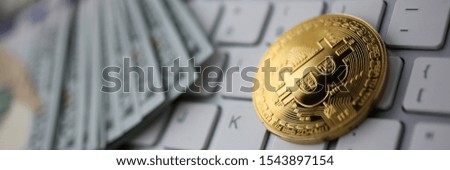 Coin crypto currency bitcoin lies on the keyboard background theme gold exchange pyramid for money due to rise or fall exchange rate closeup