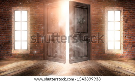 Dark room with large windows and open doors. Old brick walls, wooden floor. Sunlight shines through windows, rays, glare. Abstract room. Magical atmosphere.