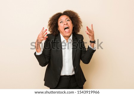 Young business african american woman screaming with rage.