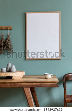 Interior design of dining room with mock up poster frame, wooden table , chair, kitchen accessories, herbs and elegant accessories. Eucaltyptus color concept. Template. Stylish home decor.