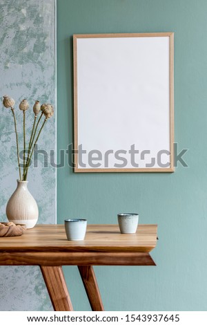 Stylish scandinavian dining room interior with mock up poster frame, wooden table, furniture, cups of coffee, flowers in vase and elegant accessories. Ready to use. Template. Modern home decor.