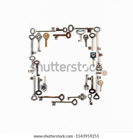 Creative frame composition made with various old keys on white background. Retro pattern. Security concept. Flat lay, top view. Copy space
