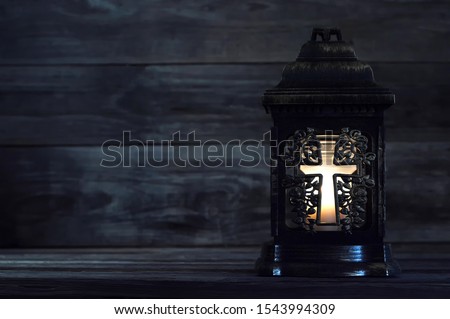 All Saints Day. Votive candle on dark background with copy space Royalty-Free Stock Photo #1543994309
