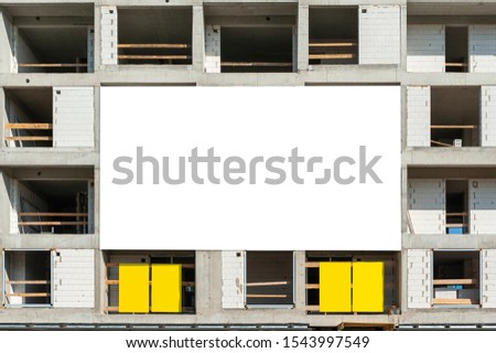 Blank white advertising banner mockup on the building under construction