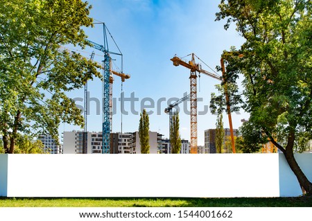 Blank white banner for advertisement on the fence of construction site