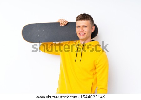Young handsome man over isolated white background with skate