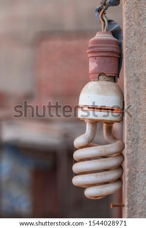 old vintage led lamp hanging on stone wall turned off with some of spider net Royalty-Free Stock Photo #1544028971