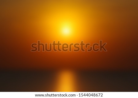 Setting sun over the sea on a blurred background