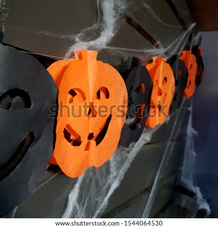 Macro photo Halloween pumpkin paper garland. Stock photo Halloween pumpkin paper garland concept art