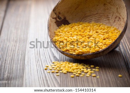 Lentils wooden bowl on wooden background. Healthy food.