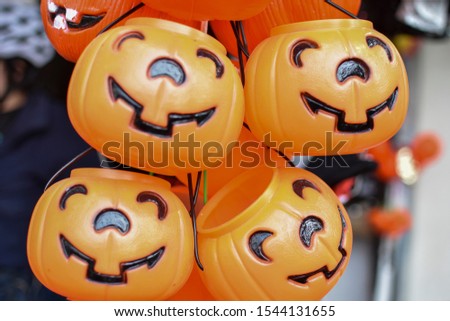 Orange plastic pumpkins in order to ask trick or treat and candies, during the Halloween and Day of the Dead holidays