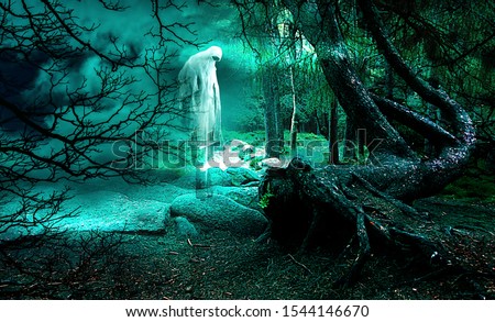 Scary ghost in spooky forest in the night. Halloween background.