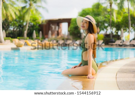 Portrait beautiful asian women happy smile relax around swimming pool in hotel resort for holiday vacation