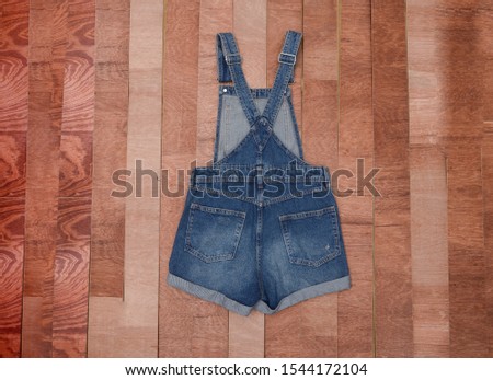 womens summer clothes with seam on wooden background ,Jeans overall 


