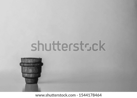 Minimalism. Cork cap from a pharmacy bottle bottom left on a gray background with copy space. Black and white photography.