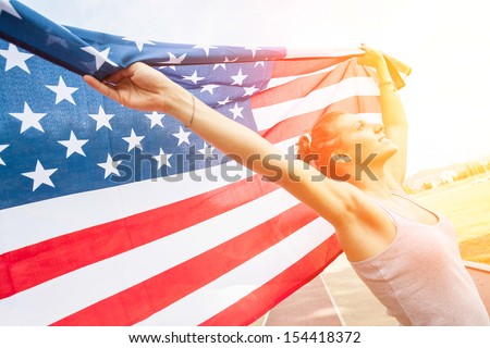 Beautiful Young Woman with USA Flag Royalty-Free Stock Photo #154418372