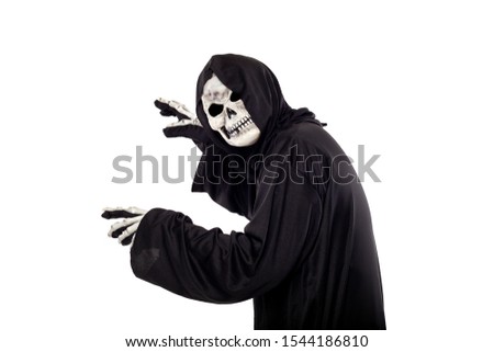 The grim reaper or death halloween costume isolated on a white background.  The skeleton is wearing a hooded black robe. Side view in profile for composites.