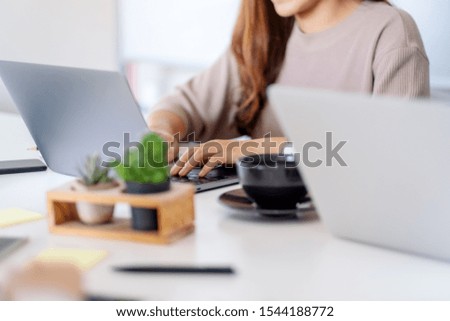 Closeup image of businessman using and working on laptop computer together in office
