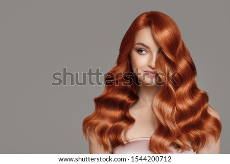 Portrait of beautiful redhair woman. Wavy hairstyle.