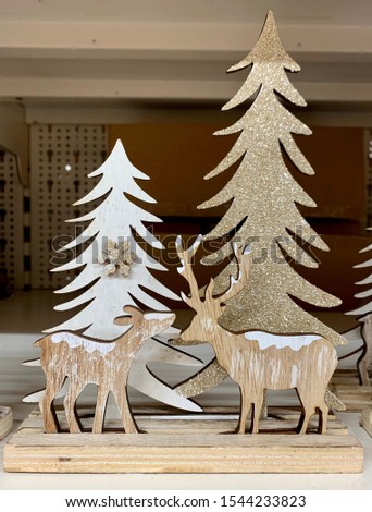 Christmas wooden decoration with deers and fir trees and snowflakes
