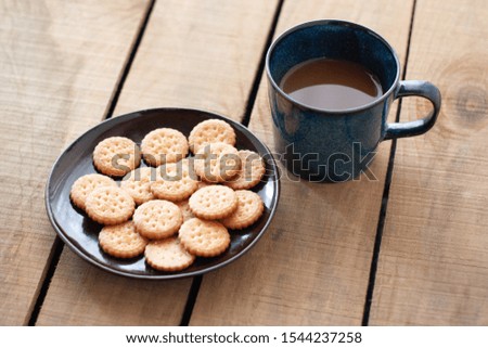 cookies in a plate with a cup of coffee