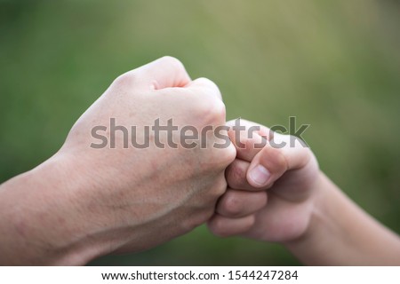 Fist bump. Child and adult fist. Child and father.