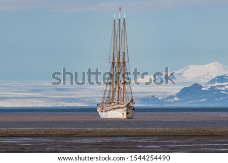 A white ship waiting for the rising tide