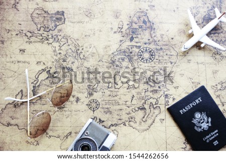 Top view of travel concept,  a world map,  camera,  passport airplane models,  glasses,  vintage cameras With copy spaces