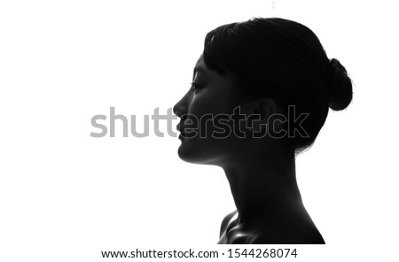 Silhouette of profile of a young asian girl. Royalty-Free Stock Photo #1544268074