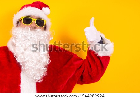 Santa Claus making the ok sign on yellow background