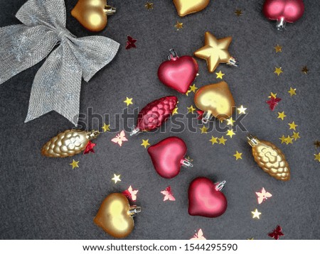 Christmas or New Year holiday background, texture, wallpaper. Christmas glass festive decoration toys and balls over dark woolen background, top view, copy space
