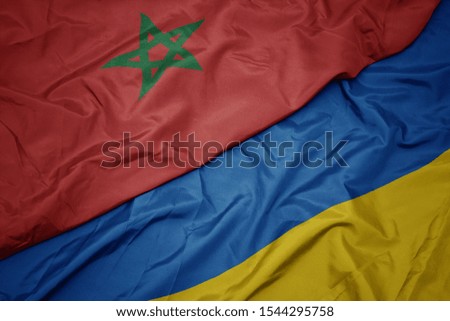 waving colorful flag of ukraine and national flag of morocco. macro