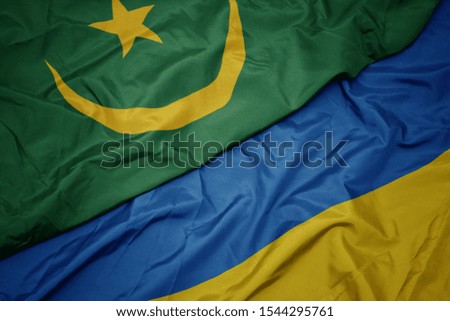 waving colorful flag of ukraine and national flag of mauritania. macro