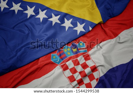waving colorful flag of croatia and national flag of bosnia and herzegovina. macro Royalty-Free Stock Photo #1544299538