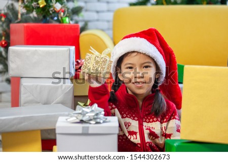 Cute asian child girl with gift boxes and decorating for celebrate on Christmas festival