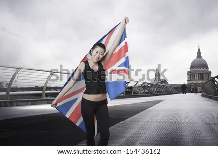 Olympic competitor with Union Jack in front of St Paul's Cathedral in London