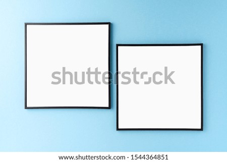 Mockup of two empty photo frames on blue background. Home decoration