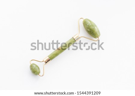 Massage roller for the face with two heads of jade stone. Health care concept Royalty-Free Stock Photo #1544391209
