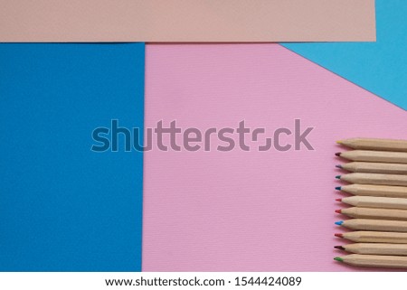 closeup blue and pink pencil on blue and pink colors background. minimal concept. colorful abstract minimalist design background, arts and crafts, school stationery