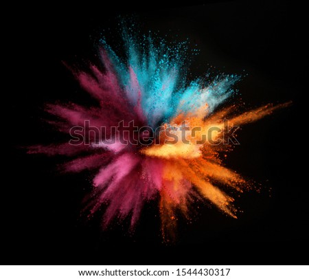Explosion of colored powder isolated on black background. Abstract colored background Royalty-Free Stock Photo #1544430317