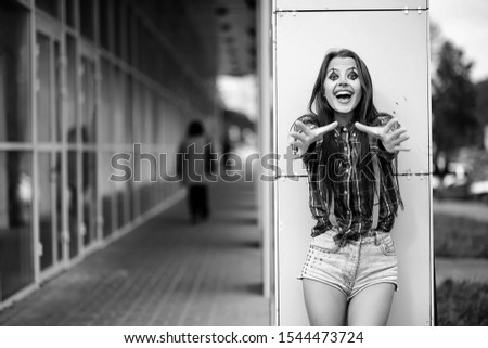 Cute girl in a clown makeup on a background black and white photo

