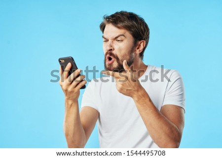 Puzzled look of a young man on a cell phone