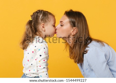 Woman in light clothes have fun with cute child baby girl 4-5 years old. Mommy little kid daughter isolated on yellow background studio portrait. Mother's Day love family parenthood childhood concept
